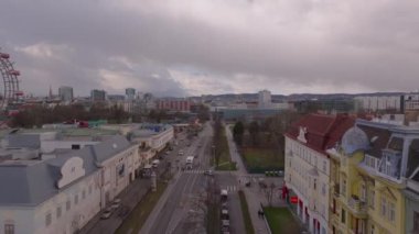 Şehir merkezindeki caddenin üzerinden uç. Park ve ünlü Wiener Riesenrad Prater 'da. Şehirde bulutlu bir gün. Viyana, Avusturya.