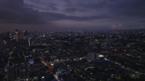 夕暮れ時の大都市の空中パノラマビュー 夜はメトロポリスの上空を飛行する 暗い空に雲がある マニラ フィリピン — ストック動画