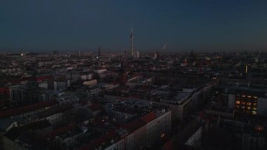 Alacakaranlıkta yerleşim yerindeki apartmanların hava panoramik manzarası. Uzaktan iyi bilinen turistik yerler. Berlin, Almanya.
