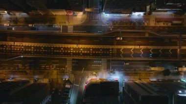 Gece şehrinde çok katlı ve çok şeritli caddelerde giden araçların en tepeye tırmanan görüntüsü. Metropolis 'te taşıma altyapısı. Osaka, Japonya.