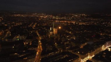 Genevas 'ın büyüleyici hava manzarası gece parlıyor, canlı şehir ışıklarını ve St Pierre Katedrali' ni yakalıyor..