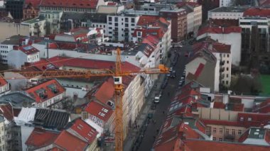 Tarihi binalar ve Berlins şehrindeki işlek caddeler arasında bir vinç ve şantiye manzarası.