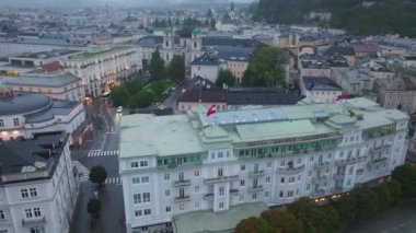 Geleneksel binaları Dreifaltigkeitskirche ve Salzach Nehri 'nin aktığı Salzburg tarihi şehir merkezinin havadan görünüşü.