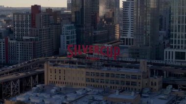 Gün ışığını ısıtan Silvercup Stüdyoları Long Island City, Queens 'teki ikonik çatı tabelası. Şehir trafiği, New York manzarası boyunca yükselen tren..