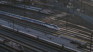 New York 'ta bir tren istasyonuna park etmiş olan Amtrak treninin görüntüsü, metropoliten ulaşım ağını ve banliyö hareketlerini vurguluyor..