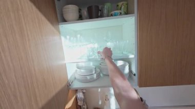 Mutfak gereçlerini düzenlemek, sabahları makineyle kahve hazırlamak şık, çağdaş daire içi, Berlin, 5.8.2025.