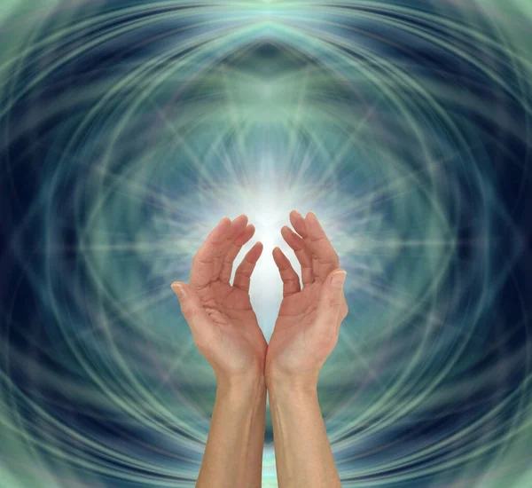Matrix Energy Healing Hands Sensing star light - Dark blue deep teal green background with cupped female hands reaching up into star light formation with space for spiritual message