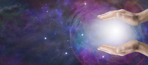 Работа с энергией шара космического исцеления - самец держит энергетический шар между открытыми параллельными руками на обширном пространстве глубокого космоса с копировальным пространством для духовного послания