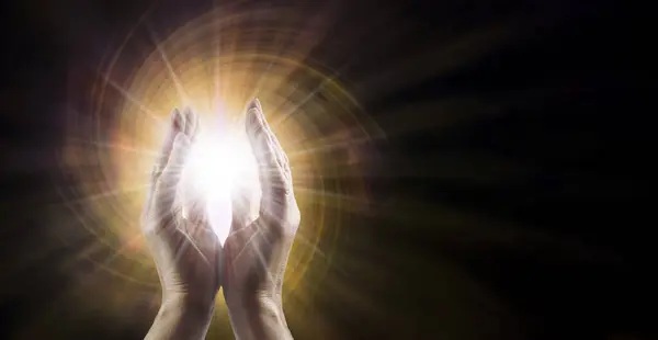 Reiki Distant Healing Concept Template - Male Reiki Master Healer with parallel hands reaching into white star orb light against golden vortex energy field with copy space for spiritual message
