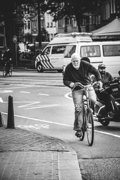 stock image Amsterdam, the Netherlands: october 13, 2017: People cycling in the streets of Amsterdam. Black and white urban photography