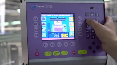 İşçi, tablet bilgisayarlı bir Cnc makinesi programlıyor. Tekstil Fabrikası