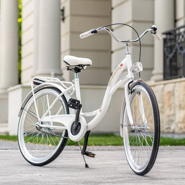 stock image View of urban city bicycle parked on street in neighborhood. Sun bike summer. No people.