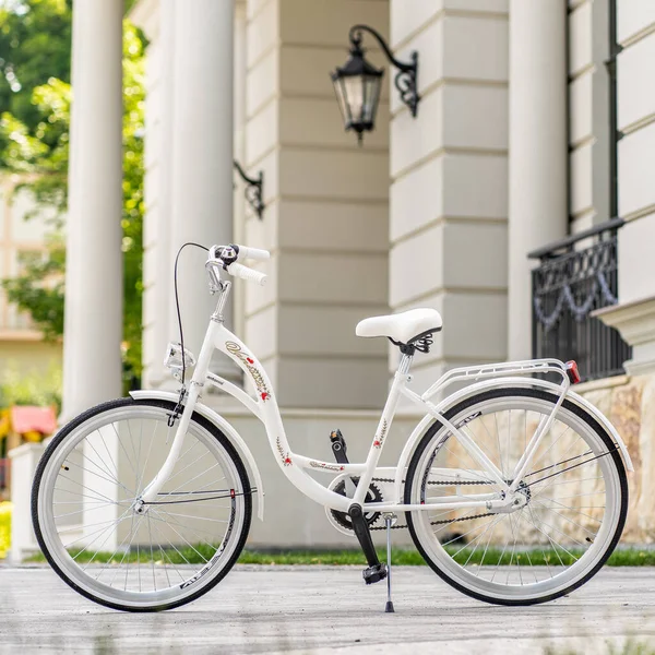 Stock image View of urban city bicycle parked on street in neighborhood. Sun bike summer. No people.