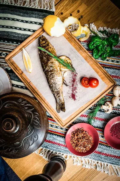 Grilled fish, salads and vegetables. Seafoods, grilled meat, meze, raki, ouzo, appetizers and salads on the table in Greek or Turkish Fish Restaurant for dinner or lunch at the beach.