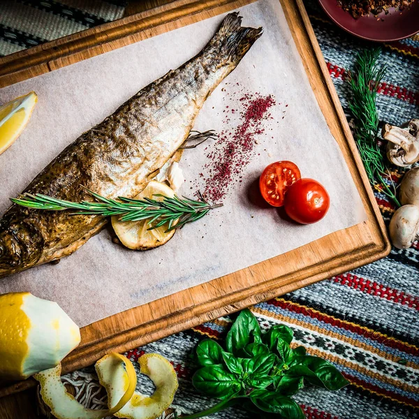 Grilled fish, salads and vegetables. Seafoods, grilled meat, meze, raki, ouzo, appetizers and salads on the table in Greek or Turkish Fish Restaurant for dinner or lunch at the beach.