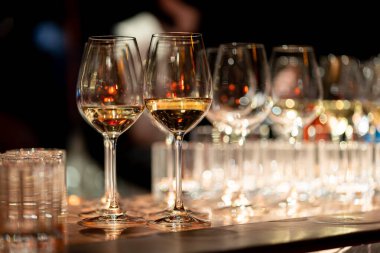 Barmen kırmızı şarabı bardaklara doldurur.