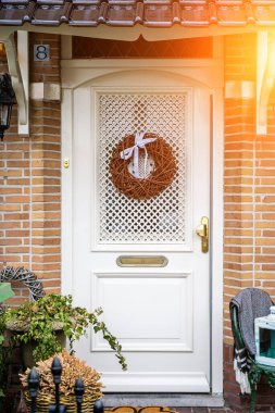 Facade of typical Dutch door house with brick walls, steps, front door windows. Doors on the street, Netherlands clipart