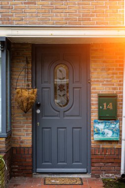 Facade of typical Dutch door house with brick walls, steps, front door windows. Doors on the street, Netherlands clipart