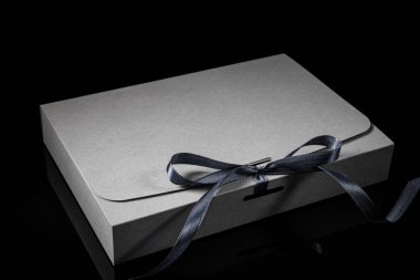 Erkek hediye konsepti. Arkaplanda lüks bir fiyonk olan hediye kutusu. Kopyalama alanı ile yatay.