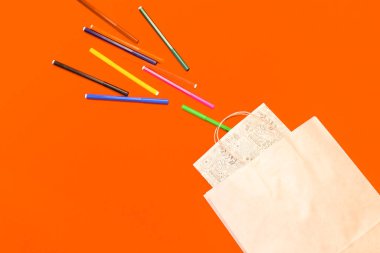 Renkli arka planda en üstteki kahverengi kağıt alışveriş torbası, boş kahverengi kağıt alışveriş torbası ve fotokopi alanı. Düz yatıyordu.