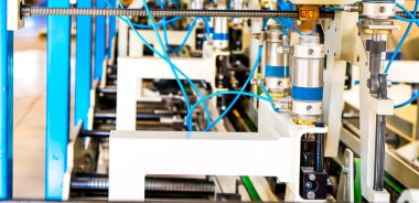 Kutulardaki ve bitmiş ürünlerdeki karton paketlerin montajı. Mekanizma üretim endüstrisi