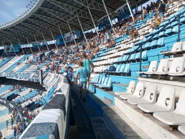 BUENOS AIRES, ARGENTINA - CIRCA MARCH 2023: Fans at the Racing Club de Avellaneda stadium in Buenos Aires circa March 2023 in Buenos Aires. clipart