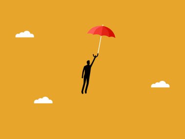 İş adamı elinde şemsiyeyle özgürce uçuyor.