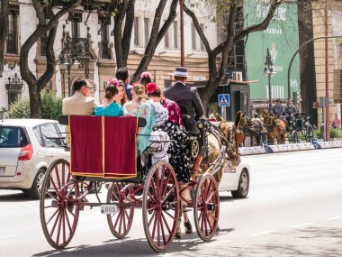Seville, Spain - May 04, 2022 : Horse carriage heading to the April Fair in Seville, Andalusia, Spain.
