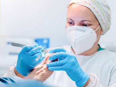 Ayak hastalıkları kliniğinde ayak masajı yapan bir kadın ayak hastalıkları uzmanı. Seçici odak