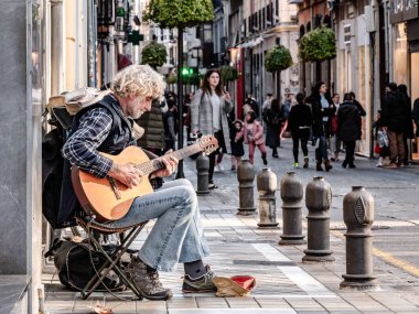 Granada, İspanya - 01 Şubat 2020: Bir adam para kazanmak için sokakta gitar çalıyor