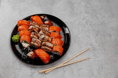 Siyah tabakta dört çeşit suşi. Üst görünüm
