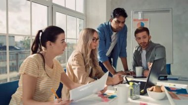 Girl explaning Project to his Team. Creative team Working at Office. Team making Presentation. Office Team are Working Together.