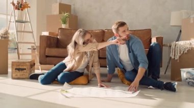 Couple Discussing Flat Plan. Couple Moving in new Home.