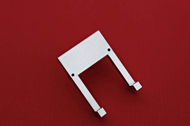 kırmızı bir yüzeyde metal bir nesne