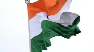 India flag flying high at Connaught Place with pride in blue sky, India flag fluttering, Indian Flag on Independence Day and Republic Day of India, tilt up shot, Waving Indian flag, Har Ghar Tiranga