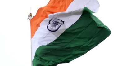 India flag flying high at Connaught Place with pride in blue sky, India flag fluttering, Indian Flag on Independence Day and Republic Day of India, tilt up shot, Waving Indian flag, Har Ghar Tiranga