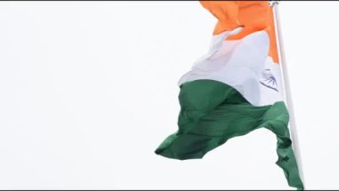 India flag flying high at Connaught Place with pride in blue sky, India flag fluttering, Indian Flag on Independence Day and Republic Day of India, tilt up shot, Waving Indian flag, Har Ghar Tiranga