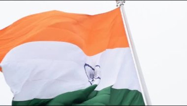 India flag flying high at Connaught Place with pride in blue sky, India flag fluttering, Indian Flag on Independence Day and Republic Day of India, tilt up shot, Waving Indian flag, Har Ghar Tiranga