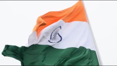 India flag flying high at Connaught Place with pride in blue sky, India flag fluttering, Indian Flag on Independence Day and Republic Day of India, tilt up shot, Waving Indian flag, Har Ghar Tiranga