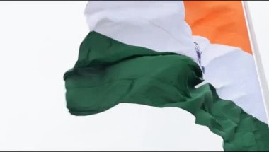 India flag flying high at Connaught Place with pride in blue sky, India flag fluttering, Indian Flag on Independence Day and Republic Day of India, tilt up shot, Waving Indian flag, Har Ghar Tiranga