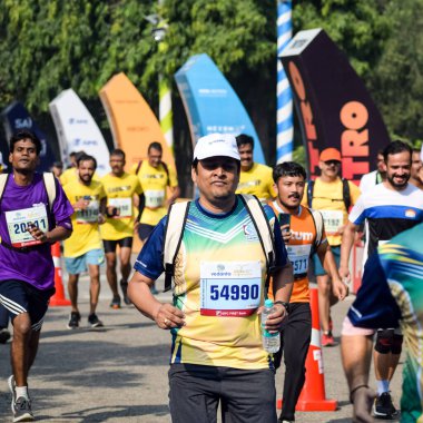 Yeni Delhi, Hindistan - 16 Ekim 2022 - Bitmek üzere olan maraton katılımcılarının bitiş çizgisini geçmek üzere olan Delhi Yarı Maratonu 2022