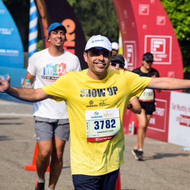 Yeni Delhi, Hindistan - 16 Ekim 2022 - Bitmek üzere olan maraton katılımcılarının bitiş çizgisini geçmek üzere olan Delhi Yarı Maratonu 2022