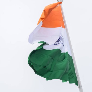 India flag flying high at Connaught Place with pride in blue sky, India flag fluttering, Indian Flag on Independence Day and Republic Day of India, tilt up shot, Waving Indian flag, Har Ghar Tiranga