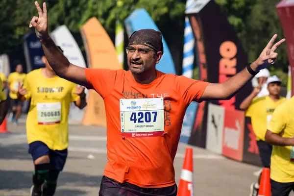 stock image New Delhi, India - October 16 2022 - Vedanta Delhi Half Marathon race after covid in which marathon participants about to cross the finish line, Delhi Half Marathon 2022