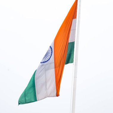 India flag flying high at Connaught Place with pride in blue sky, India flag fluttering, Indian Flag on Independence Day and Republic Day of India, tilt up shot, Waving Indian flag, Har Ghar Tiranga