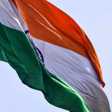India flag flying high at Connaught Place with pride in blue sky, India flag fluttering, Indian Flag on Independence Day and Republic Day of India, tilt up shot, Waving Indian flag, Har Ghar Tiranga