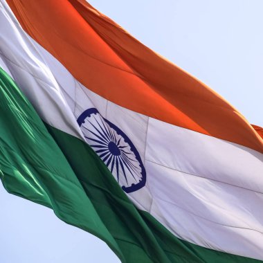 India flag flying high at Connaught Place with pride in blue sky, India flag fluttering, Indian Flag on Independence Day and Republic Day of India, tilt up shot, Waving Indian flag, Har Ghar Tiranga