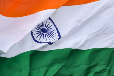 India flag flying high at Connaught Place with pride in blue sky, India flag fluttering, Indian Flag on Independence Day and Republic Day of India, tilt up shot, Waving Indian flag, Har Ghar Tiranga