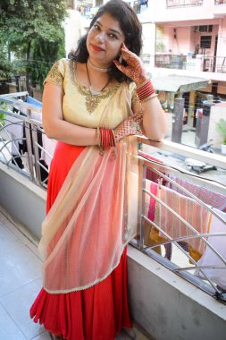 Hint geleneği gibi giyinmiş güzel bir kadın. İki elinde de Henna Mehndi tasarımı var. Hintli bir kadının kocası için Karwa Chauth ve Karwa Chauth kutlamalarını kutlamak için.