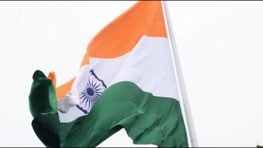 India flag flying high at Connaught Place with pride in blue sky, India flag fluttering, Indian Flag on Independence Day and Republic Day of India, tilt up shot, Waving Indian flag, Har Ghar Tiranga
